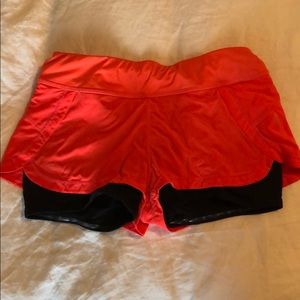Athleta 2 in 1 flex shorts in bright orange